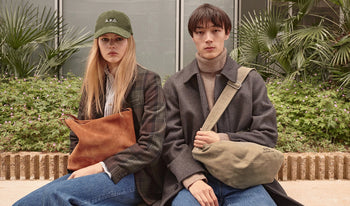 A.P.C. Women Sale Bags - Woman and man sitting together wearing coat and jeans.