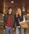 A.P.C. Academy - Man and woman standing in front of university entrance wearing collegiate clothing.