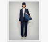 A.P.C. Women - Woman wearing matching pinstripe jacket and pants with navy baseball cap.