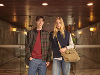 A.P.C. Academy - Man and Woman standing together wearing collegiate style clothing.