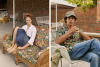 A.P.C. Summer Romance - Woman wearing pink shirt and denim skirt sitting on backyard couch. Man wearing aloha shirt and denim jeans sitting on a backyard chair.