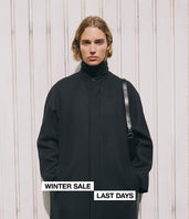 A.P.C. Women's Sale - woman model in winter coat against a light background