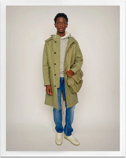 A.P.C. Journal - Man wearing green parka and blue jeans.