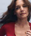 A.P.C. Katie Holmes Interaction - Katie Holmes wearing red sweater holding necklace.