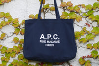 A.P.C. Women Gift Me More - Blue tote bag laying in leaves.