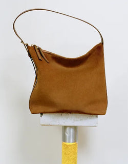 A.P.C. Fall/Winter Campaign - Brown Vera bag sitting on tile stand.