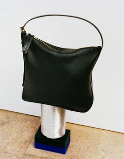 A.P.C. Fall/Winter Campaign - Black Vera bag sitting on a metal cylinder.